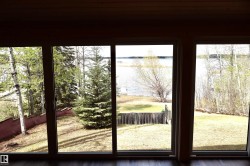 Multiple large-pane windows showcase the expansive outdoor landscape - 