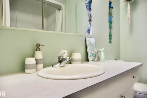 Bathroom vanity with an integrated oval sink, chrome faucet, and ample countertop space - #26 5508 Twp Rd 593A, Rural Barrhead County, AB - Indoor Photo Showing Bathroom
