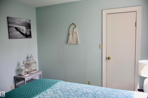 Light blue wall color and white trim door - #26 5508 Twp Rd 593A, Rural Barrhead County, AB - Indoor Photo Showing Bedroom