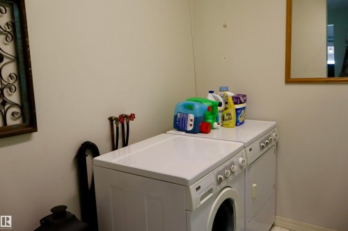 Dedicated laundry area featuring a white stackable washer and dryer unit - #26 5508 Twp Rd 593A, Rural Barrhead County, AB - Indoor Photo Showing Laundry Room
