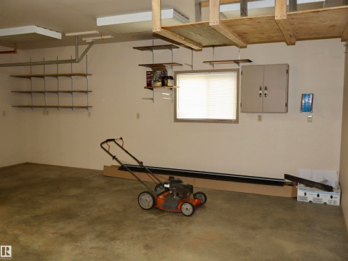 Interior garage space featuring a concrete floor - #26 5508 Twp Rd 593A, Rural Barrhead County, AB - Indoor Photo Showing Garage