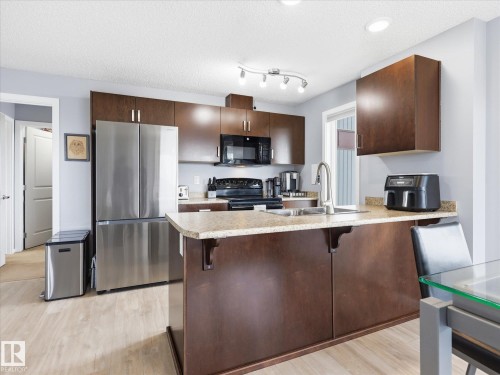 302 5521 7 Avenue, Edmonton, AB - Indoor Photo Showing Kitchen With Stainless Steel Kitchen With Double Sink