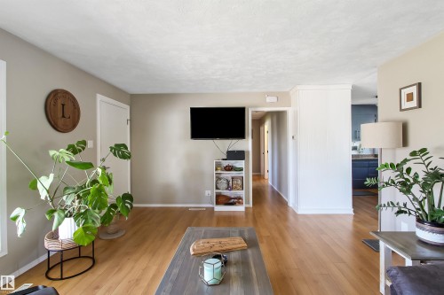 Light wood-finish flooring complements neutral wall tones and white trim - 803 12 Avenue, Cold Lake, AB - Indoor