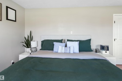 Neutral-toned walls complement a light-colored headboard - 803 12 Avenue, Cold Lake, AB - Indoor Photo Showing Bedroom