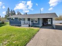 Single-story dwelling featuring blue siding and a dark shingle roof - 803 12 Avenue, Cold Lake, AB  - Outdoor With Deck Patio Veranda 