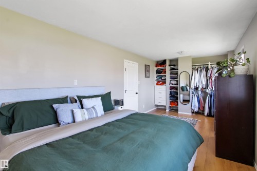 Bedroom featuring light-toned walls and wood-finish flooring - 803 12 Avenue, Cold Lake, AB - Indoor Photo Showing Bedroom