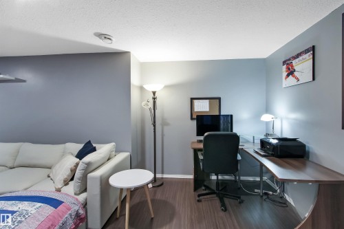 Open-concept room featuring wood-finish flooring and light gray walls - 803 12 Avenue, Cold Lake, AB - Indoor Photo Showing Office