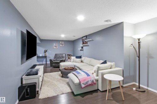 Spacious room featuring wood-finish flooring and light blue walls - 803 12 Avenue, Cold Lake, AB - Indoor