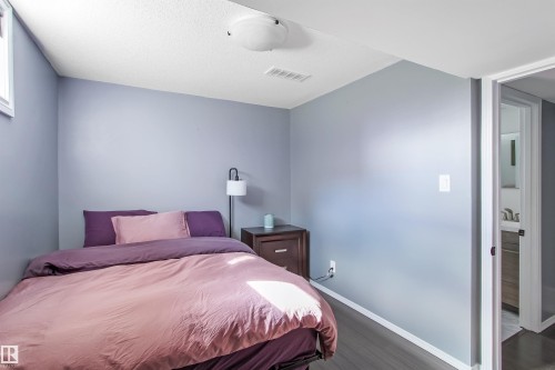 Bedroom with wood-finish flooring and a single window - 803 12 Avenue, Cold Lake, AB - Indoor Photo Showing Bedroom