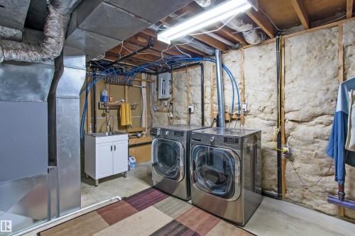 Utility space featuring exposed ceiling joists and concrete flooring - 803 12 Avenue, Cold Lake, AB - Indoor Photo Showing Laundry Room