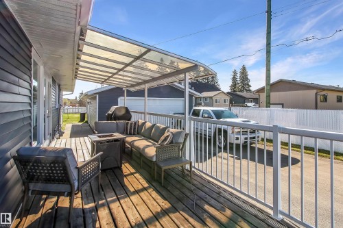 Expansive outdoor deck featuring wood-finish flooring and a translucent overhead covering - 803 12 Avenue, Cold Lake, AB - Outdoor With Deck Patio Veranda With Exterior