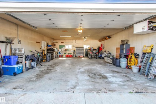 Spacious garage with concrete flooring, overhead lighting, and white walls - 803 12 Avenue, Cold Lake, AB - Indoor Photo Showing Garage
