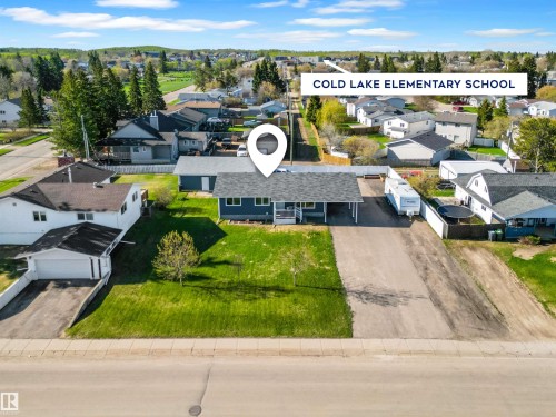 Property featuring a gray exterior with white trim, a covered front porch, and an attached carport - 803 12 Avenue, Cold Lake, AB - Outdoor With View