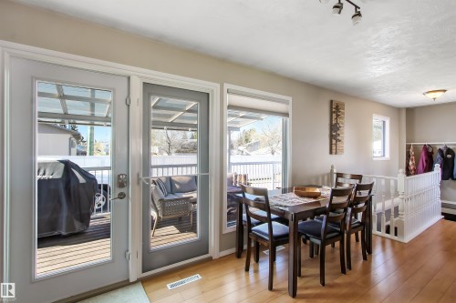 Dining area featuring light wood-finish flooring, neutral wall tones, and a six-seat dining table - 803 12 Avenue, Cold Lake, AB - Indoor Photo Showing Dining Room