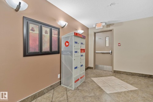 Building common area featuring durable tile flooring, neutral wall tones, and overhead lighting - 206 103 Ambleside Drive, Edmonton, AB - Indoor Photo Showing Other Room