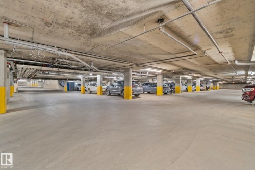 Spacious underground parking garage featuring concrete flooring and ceiling - 206 103 Ambleside Drive, Edmonton, AB - Indoor Photo Showing Garage