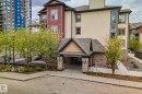 Multi-story building featuring stone accents, a covered entry, and balconies - 206 103 Ambleside Drive, Edmonton, AB  - Outdoor With Balcony 