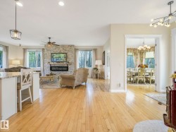 Open-concept living area with light wood-finish flooring - 
