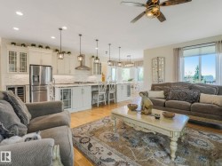 Open-concept living space featuring wood-finish flooring and recessed lighting - 