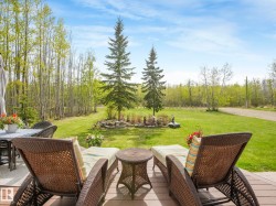 Expansive outdoor deck featuring composite decking and surrounding natural greenery - 