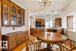 Dining area featuring a wood-finish oval table and matching chairs - 