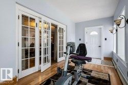 Room featuring hardwood flooring and light blue wall paint - 