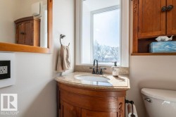 Corner vanity with an undermount sink, granite countertop, and dark-finish faucet - 