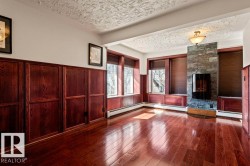 Hardwood flooring complements the stone-clad fireplace with an integrated electric insert - 