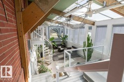 Sunroom featuring a spiral staircase, glass panel railing, and translucent ceiling panels - 