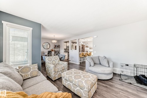 Open-concept living area featuring wood-finish flooring and light-toned walls - 267 Sturtz Bend, Leduc, AB - Indoor Photo Showing Living Room