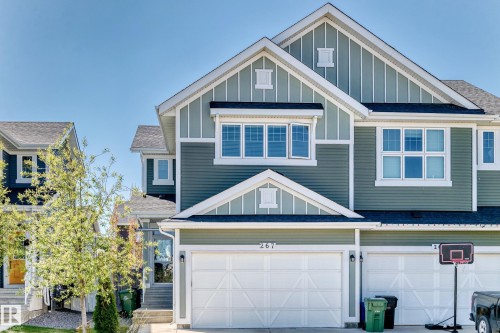 Two-story townhome with light green siding and white trim accents - 267 Sturtz Bend, Leduc, AB - Outdoor