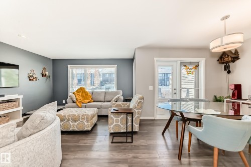 Open-concept living area featuring wood-finish flooring, recessed lighting, and a neutral color palette - 267 Sturtz Bend, Leduc, AB - Indoor Photo Showing Other Room