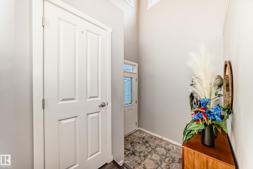 Entryway featuring high ceilings, white panel doors, and a decorative frosted glass entry door with transom window - 267 Sturtz Bend, Leduc, AB - Indoor Photo Showing Other Room