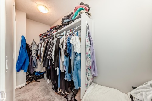 Walk-in closet featuring built-in shelving, hanging rods, and recessed lighting - 267 Sturtz Bend, Leduc, AB - Indoor With Storage