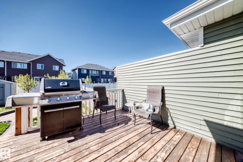 Wood-finish deck with white railings and light green siding - 267 Sturtz Bend, Leduc, AB - Outdoor With Deck Patio Veranda With Exterior