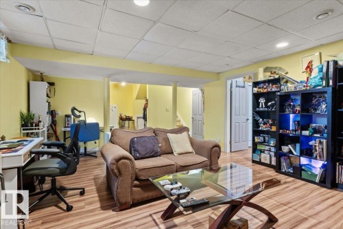 Finished lower level featuring wood-finish flooring, recessed lighting, and a drop ceiling - 3356 25 Ave, Edmonton, AB - Indoor