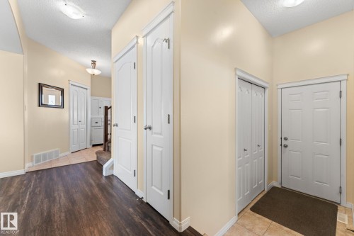 Entryway featuring dark wood-finish flooring, light tan wall color, and white trim - 112 Lakeland Point(E), Beaumont, AB - Indoor Photo Showing Other Room