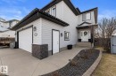 Two-story residence featuring light gray siding with dark trim, a two-car garage, and a concrete driveway - 112 Lakeland Point(E), Beaumont, AB  - Outdoor 