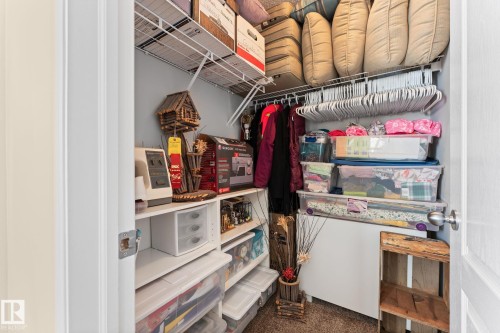 Closet featuring wire shelving, built-in rod, light gray wall paint, and white trim - 112 Lakeland Point(E), Beaumont, AB - Indoor With Storage
