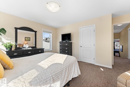 Bedroom featuring light-colored walls and soft carpet flooring - 112 Lakeland Point(E), Beaumont, AB - Indoor Photo Showing Bedroom