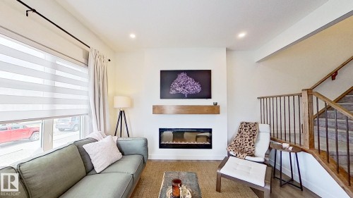 37 Emberside Link, Cochrane, AB - Indoor Photo Showing Other Room With Fireplace