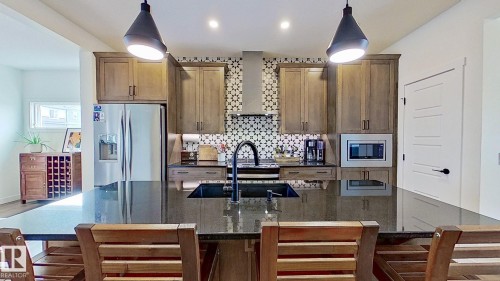 37 Emberside Link, Cochrane, AB - Indoor Photo Showing Kitchen With Double Sink With Upgraded Kitchen