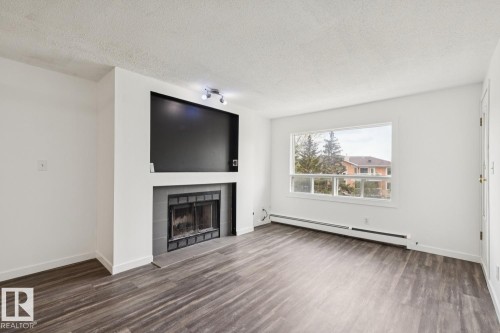 411 9010 106 Avenue, Edmonton, AB - Indoor Photo Showing Living Room With Fireplace