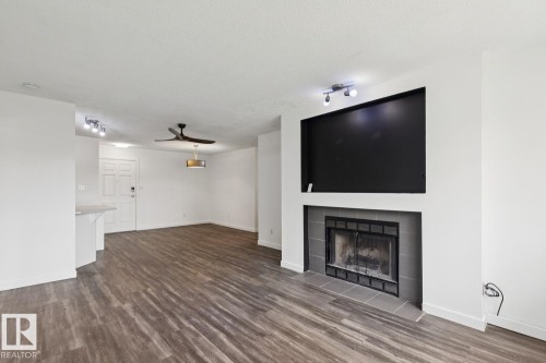 411 9010 106 Avenue, Edmonton, AB - Indoor Photo Showing Living Room With Fireplace