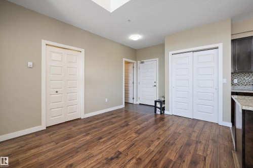 505 1238 Windermere Way, Edmonton, AB - Indoor Photo Showing Other Room With Fireplace