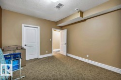 Room featuring patterned carpet flooring, neutral wall paint, and white baseboards - 