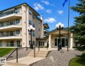 Multi-story building featuring a stucco exterior with multiple balconies, glass railings, and an entry canopy - 219 9535 176 Street, Edmonton, AB  - Outdoor 