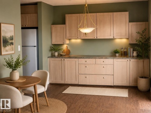 Spacious kitchen area featuring extensive light wood-finish cabinetry, under-cabinet lighting, and a coordinating countertop - 219 9535 176 Street, Edmonton, AB - Indoor