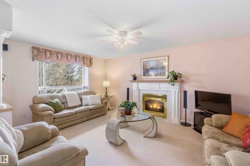 #1 Colonial Close, Beaumont, AB - Indoor Photo Showing Living Room With Fireplace