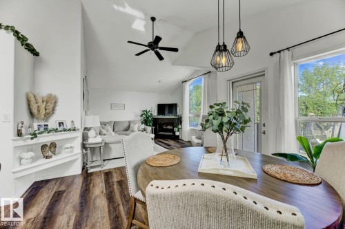 Vaulted ceilings and wood-finish flooring define this open-concept living area - 3208 135A Avenue, Edmonton, AB - Indoor Photo Showing Living Room